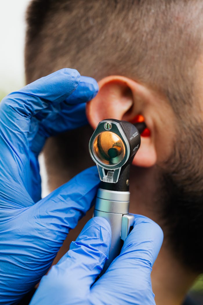 why-choose-us-02 Close-up of a doctor using an otoscope to examine a patient's ear.